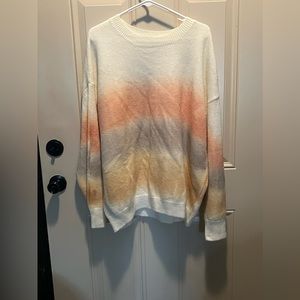 Cream sweater with neutral colors.